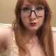 A cute redhead girl wearing glasses records herself from a between the legs perspective as she takes a shit and piss into a toilet. Presented in 720P HD. About a minute.